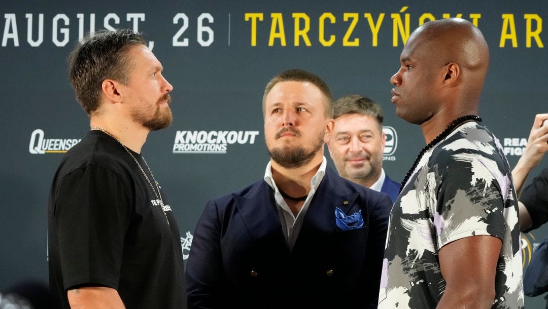 Ukraine's heavyweight boxing champion and title defender Oleksandr Usyk, left, and Britain's Daniel Dubois, right, meet the press.