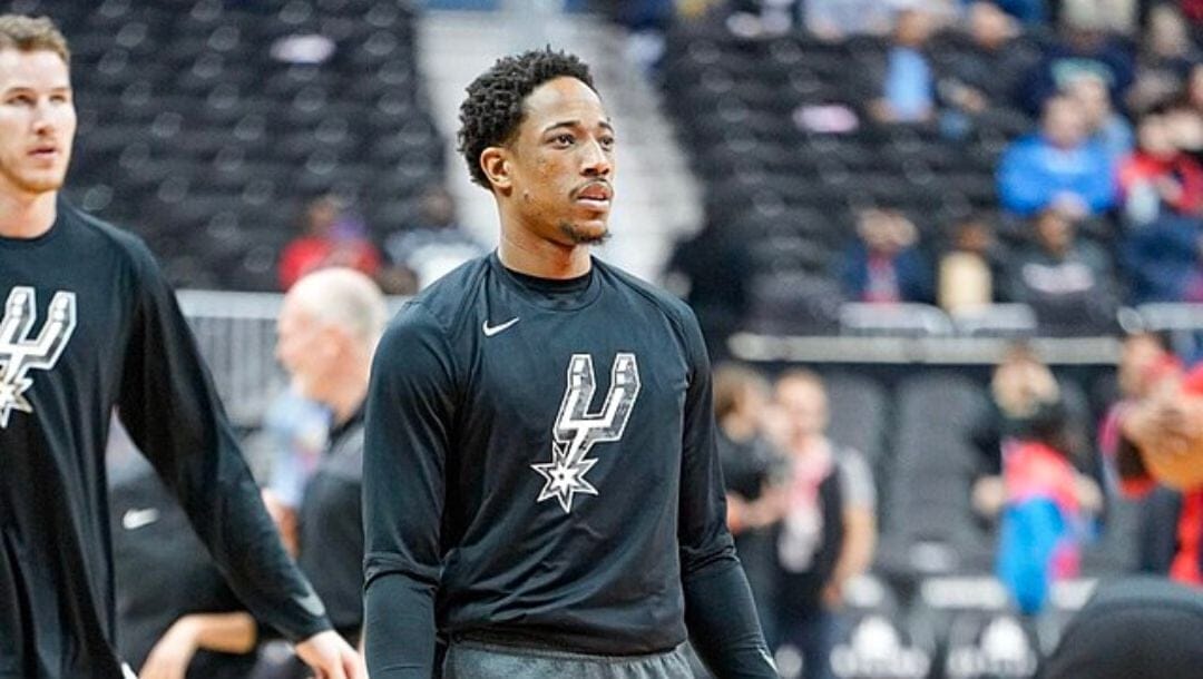 DeMar DeRozan and Jakob Poeltl of the San Antonio Spurs during warm ups for their game in April 2019.