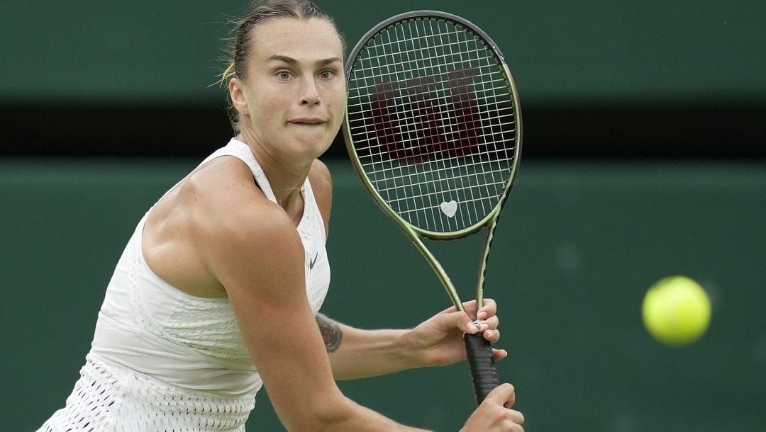 Aryna Sabalenka of Belarus in action against Tunisia's Ons Jabeur during their women's semifinal singles match on day eleven of the Wimbledon tennis championships in London, Thursday, July 13, 2023.