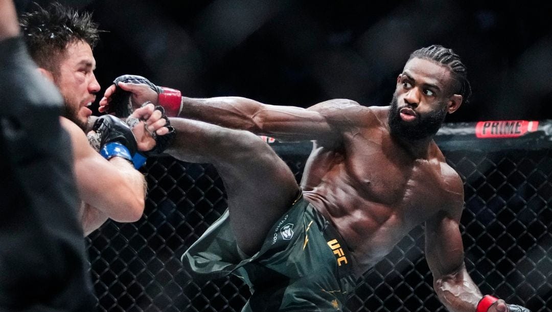 Aljamain Sterling, of Jamaica, kicks Henry Cejudo during the fifth round of a bantamweight title bout at the UFC 288.