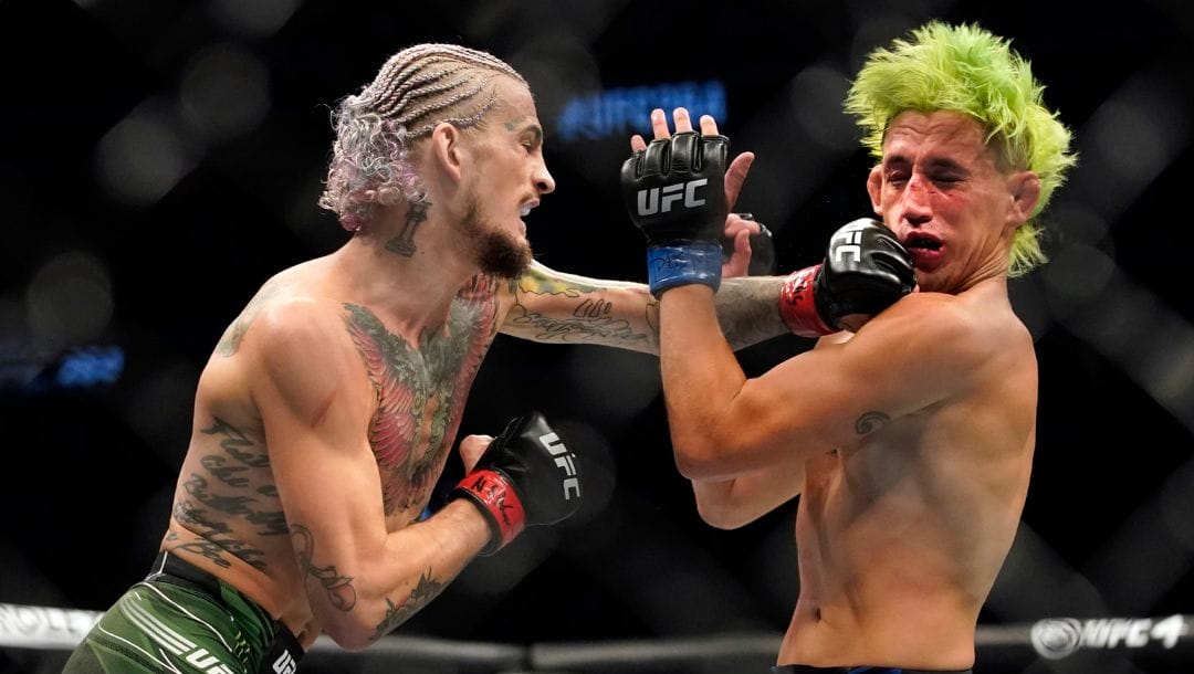 Sean O'Malley, left, punches Kris Moutinho in a UFC 264 bantamweight mixed martial arts bout Saturday, July 10, 2021.