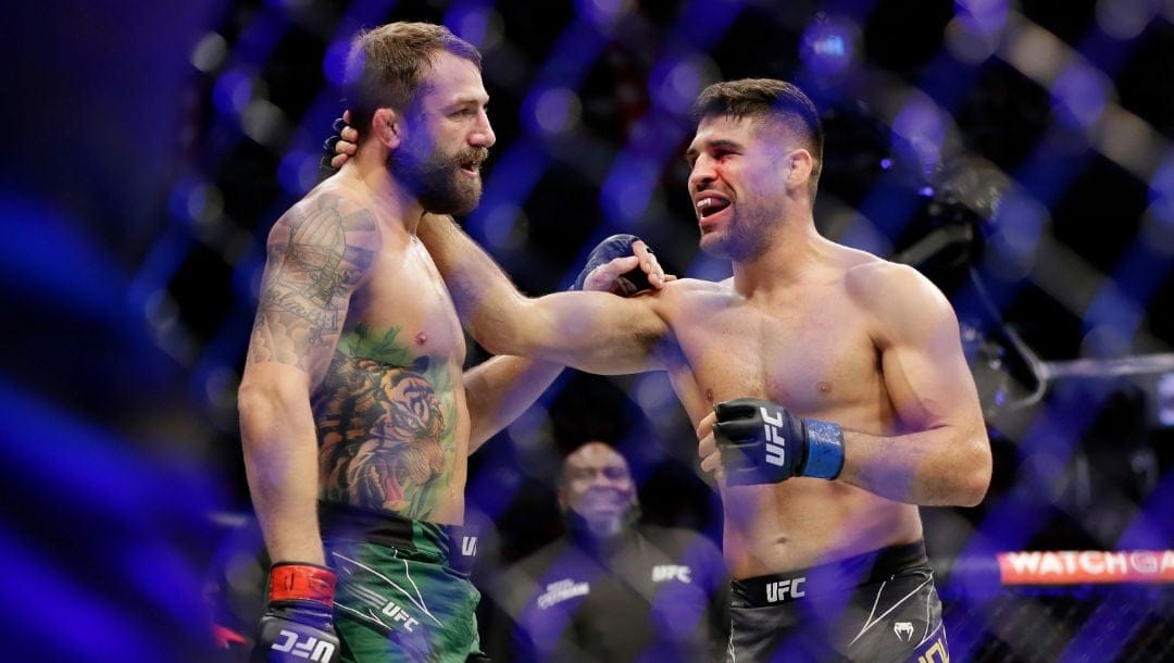 Michael Chiesa, left, Vicente Luque, right, react after Luque's win by submission in the first round.
