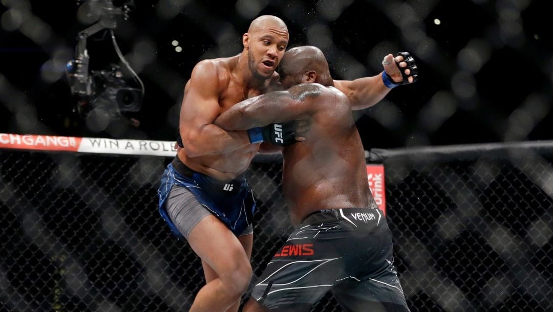 Ciryl Gane, left, and Derrick Lewis, right, compete during their interim heavyweight mixed martial arts title bout at UFC 265.