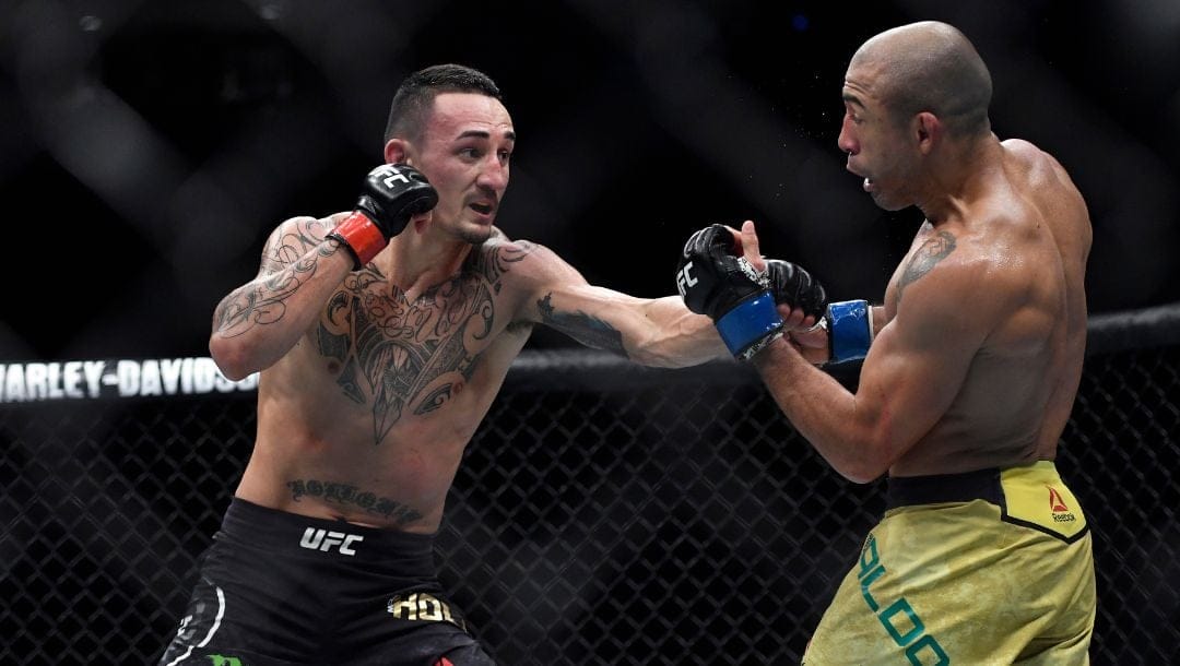 Max Holloway, left, punches Jose Aldo of Brazil in the second round during their UFC 218 featherweight mixed martial arts bout.