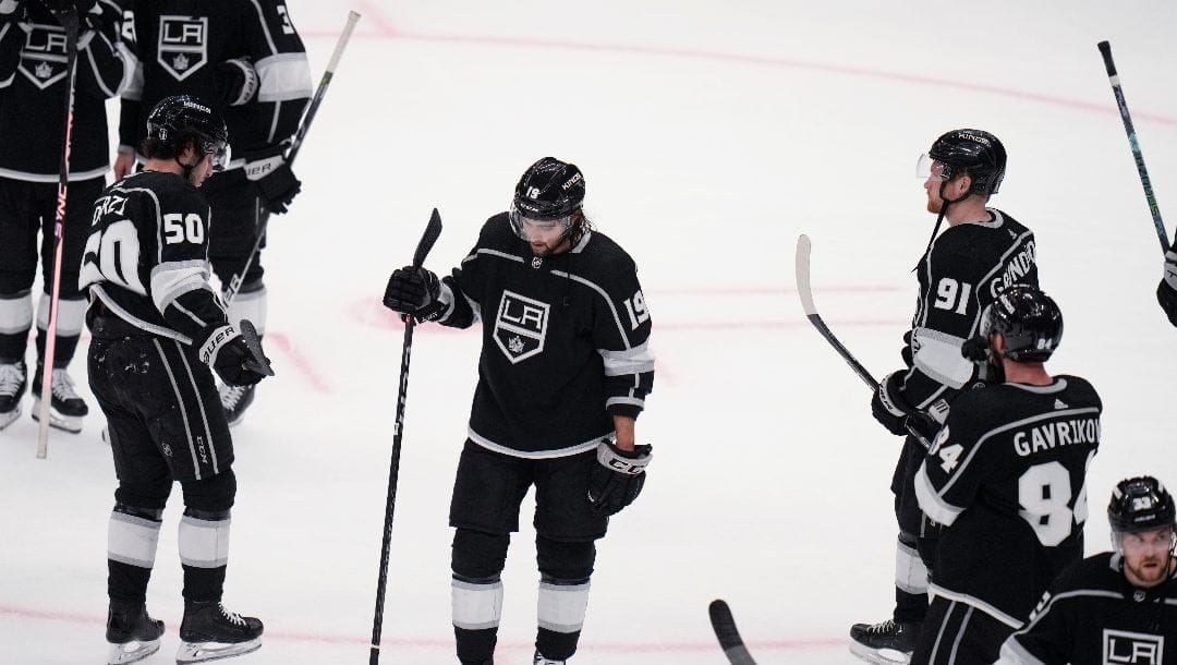 Los Angeles Kings players stand on the ice after the team's 5-4 loss to the Edmonton Oilers in Game 6 of an NHL hockey Stanley Cup first-round playoff series in Los Angeles on Saturday, April 29, 2023.
