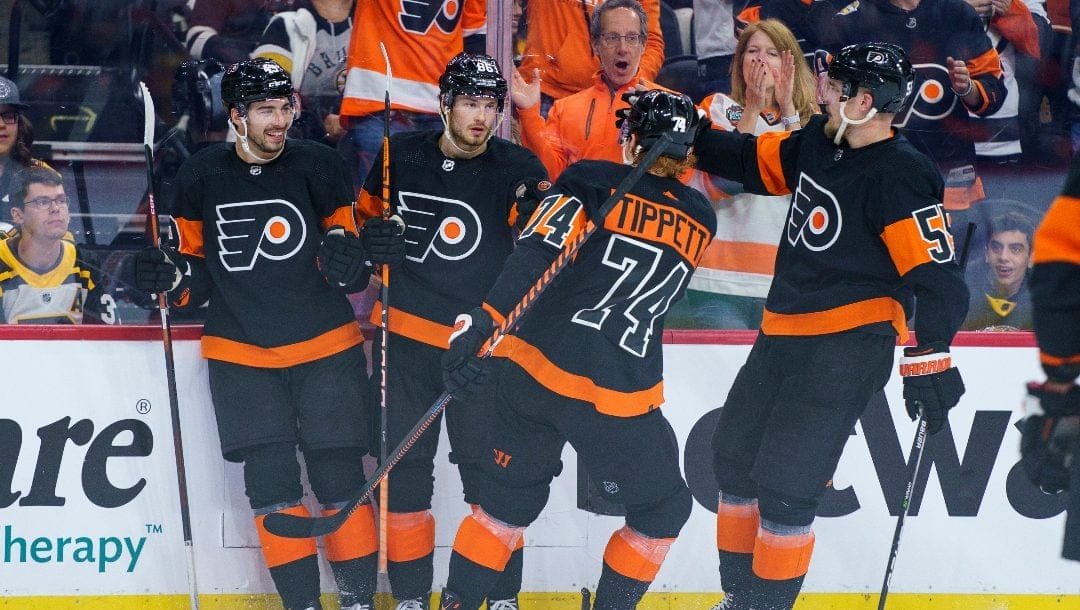 Philadelphia Flyers' Joel Farabee, center left, celebrates his goal with teammates during an NHL hockey game against the Boston Bruins, Sunday, April 9, 2023, in Philadelphia. The Bruins won 5-3.