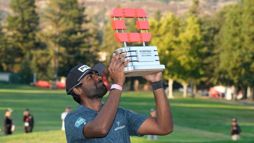 Sahith Theegala lifts his trophy on the 18th green of the Silverado Resort North Course after winning the Fortinet Championship PGA golf tournament in Napa, Calif., Sunday, Sept. 17, 2023.