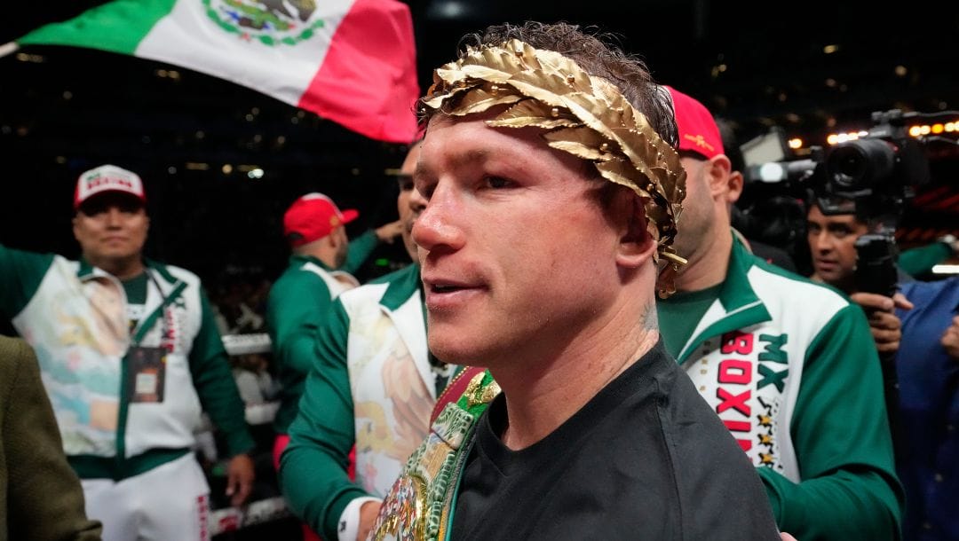 Saul "Canelo" Alvarez of Mexico celebrates after defeating John Ryder of Britain in their super middleweight title boxing match.
