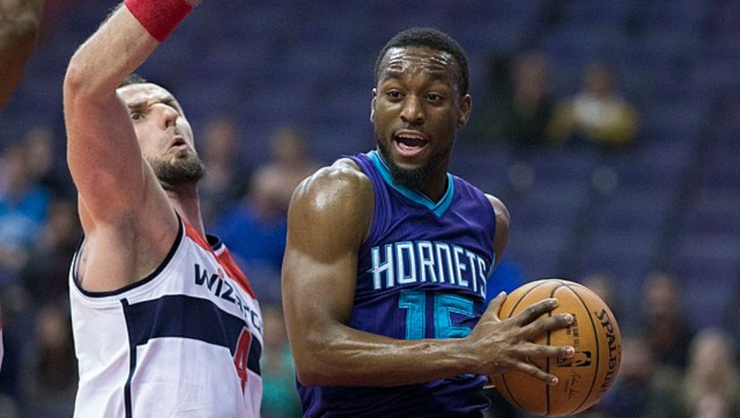 Kemba Walker of the Charlotte Hornets drives against Marcin Gortat of the Washington Wizards.