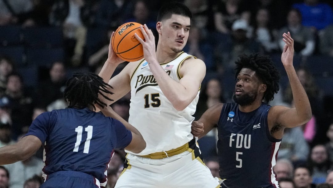 Purdue center Zach Edey (15) is defended by Fairleigh Dickinson forward Sean Moore (11) and forward Ansley Almonor (5) in the first half of a first-round college basketball game in the men's NCAA Tournament in Columbus, Ohio, Friday, March 17, 2023.