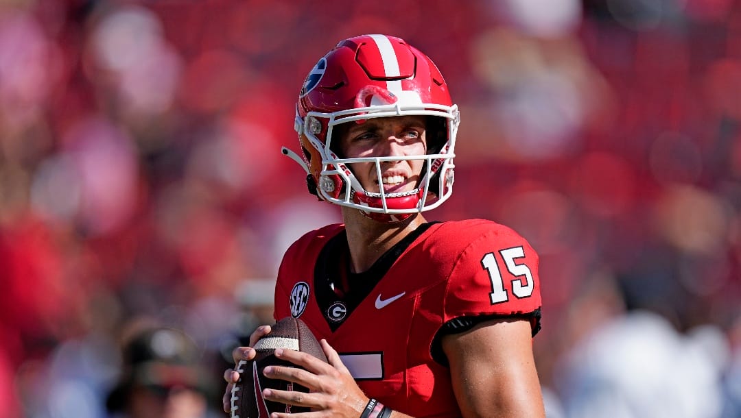Georgia quarterback Carson Beck (15) warms up before an NCAA college football game against Tennessee Martin Saturday, Sept. 2, 2023, in Athens, Ga. (AP Photo/John Bazemore)