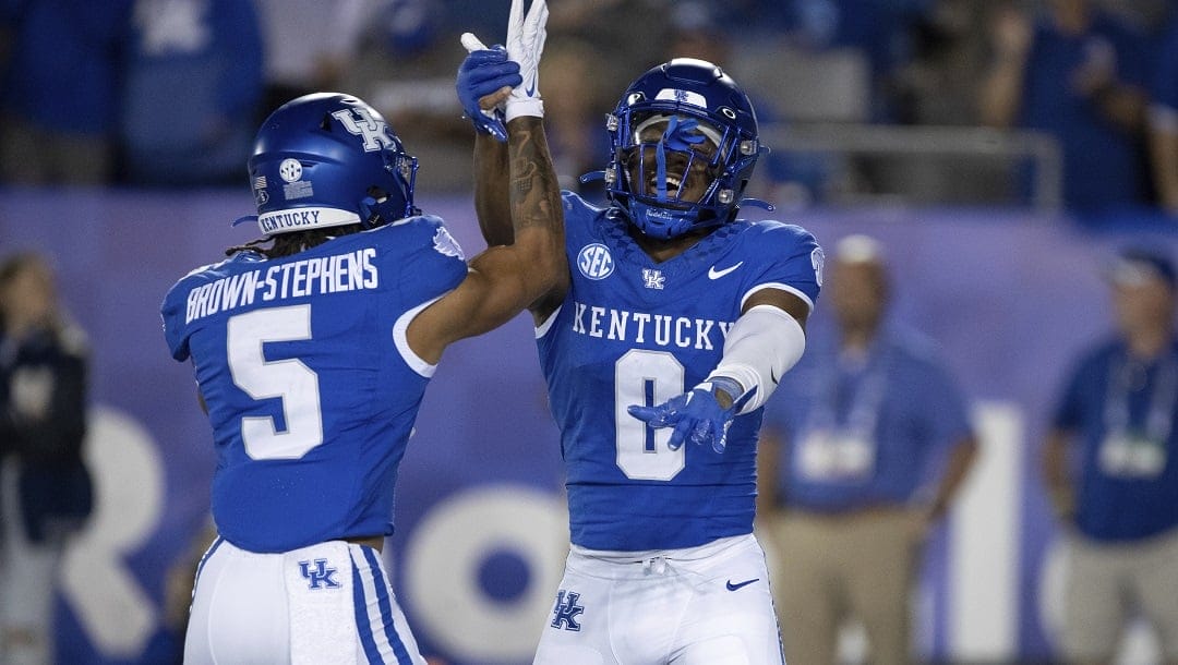 Kentucky wide receiver Anthony Brown-Stephens (5) and running back Demie Sumo-Karngbaye (0) celebrate in the end zone after a touchdown during the second half of an NCAA college football game against Akron in Lexington, Ky., Saturday, Sept. 16, 2023.