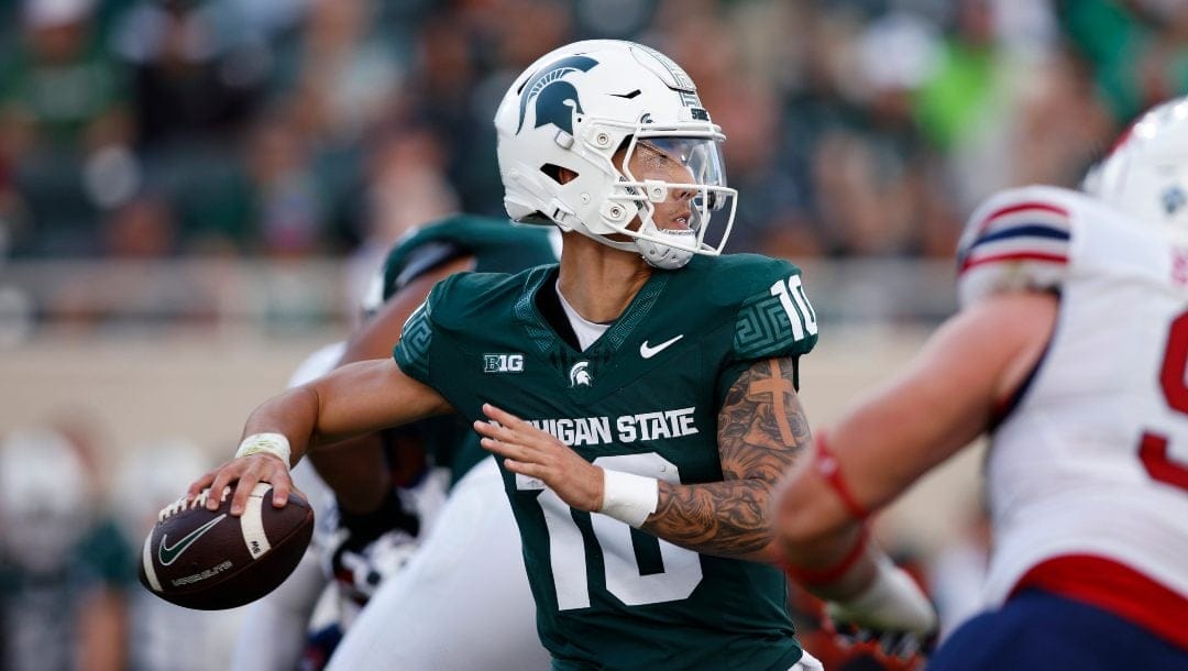 Michigan State quarterback Noah Kim looks for a receiver during the second half of the team's NCAA college football game against Richmond, Saturday, Sept. 9, 2023, in East Lansing, Mich.