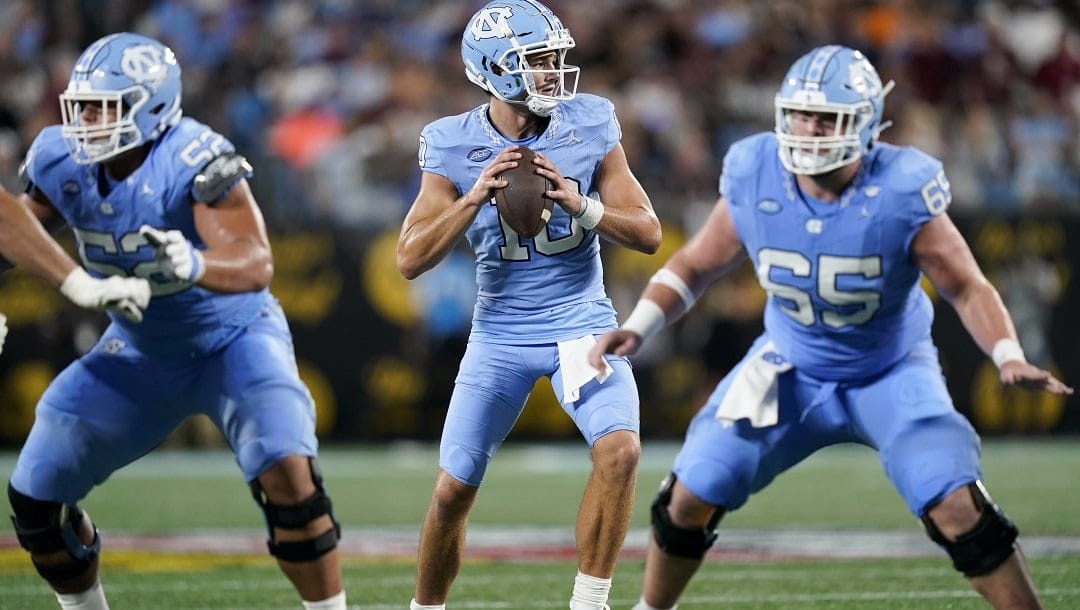 North Carolina quarterback Drake Maye, center, gets ready to throw the ball during the first half of an NCAA college football game against South Carolina Saturday, Sept. 2, 2023, in Charlotte, N.C.