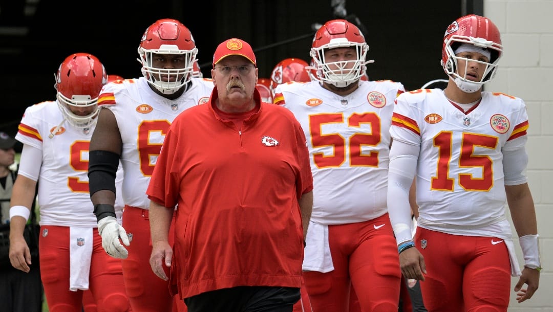 Kansas City Chiefs head coach Andy Reid and quarterback Patrick Mahomes (15) lead the team onto the field before an NFL football game against the Jacksonville Jaguars, Sunday, Sept. 17, 2023, in Jacksonville, Fla. (AP Photo/Phelan M. Ebenhack)