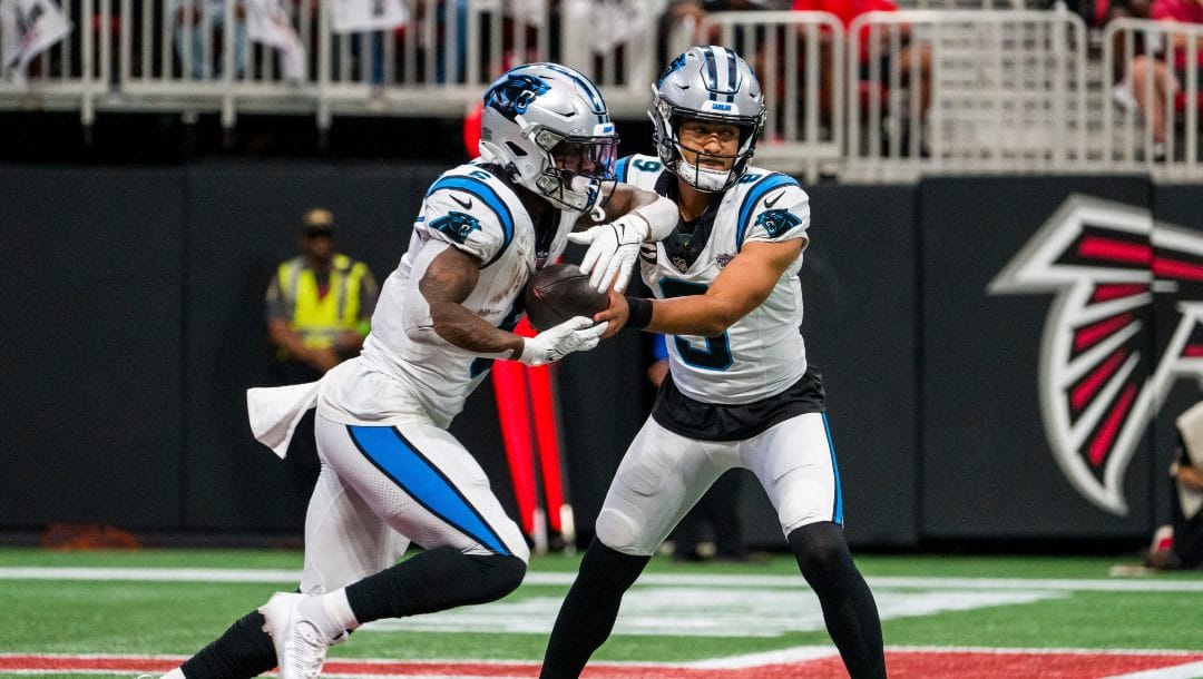 Carolina Panthers quarterback Bryce Young (9) hands off to running back Miles Sanders (6) during the first half of an NFL football game against the Atlanta Falcons, Sunday, Sep. 10, 2023, in Atlanta. The Atlanta Falcons won 24-10.
