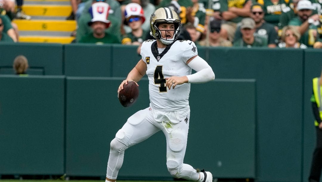 New Orleans Saints' Derek Carr runs during the first half of an NFL football game against the Green Bay Packers Sunday, Sept. 24, 2023, in Green Bay, Wis.