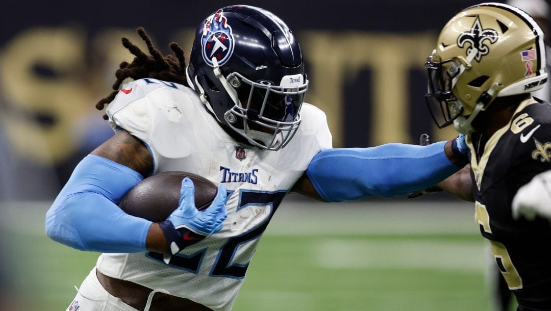 Tennessee Titans running back Derrick Henry, left, stiff arms New Orleans Saints safety Marcus Maye, right, in the first half of an NFL football game in New Orleans, Sunday, Sept. 10, 2023.