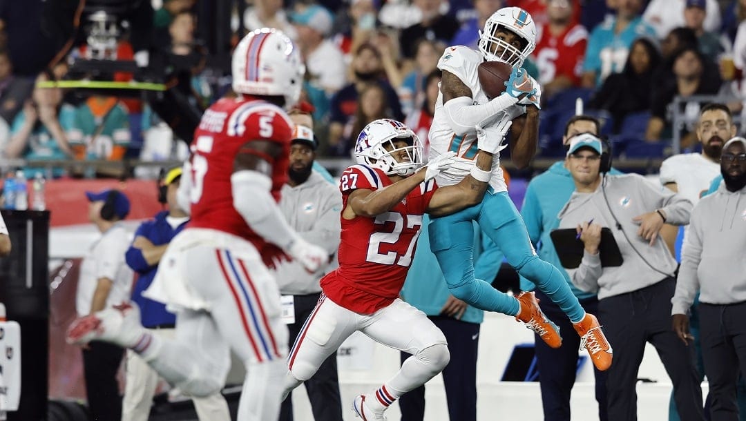 Miami Dolphins wide receiver Jaylen Waddle (17) makes a pass reception against New England Patriots cornerback Myles Bryant (27) during an NFL football game, Sunday, Sept. 17, 2023, in Foxborough, Mass.