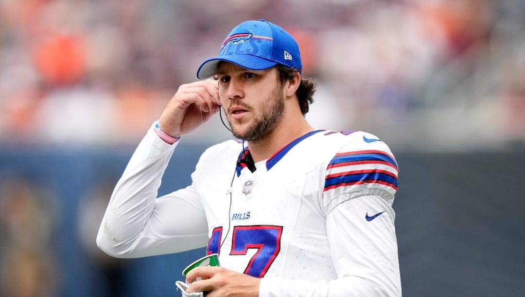 Buffalo Bills quarterback Josh Allen listens in on the play calling on the sidelines during an NFL preseason football game against the Chicago Bears Saturday, Aug. 26, 2023, in Chicago. (AP Photo/Charles Rex Arbogast)