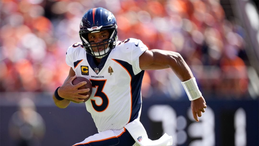 Denver Broncos quarterback Russell Wilson scrambles against the Washington Commanders in the first half of an NFL football game Sunday, Sept. 17, 2023, in Denver.