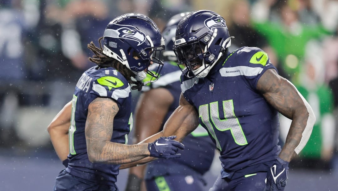Seattle Seahawks wide receiver Jaxon Smith-Njigba, left, is congratulated by wide receiver DK Metcalf after a game winning catch against the Philadelphia Eagles in the second half of an NFL football game, Monday, Dec. 18, 2023, in Seattle. The Seahawks won 20-17.