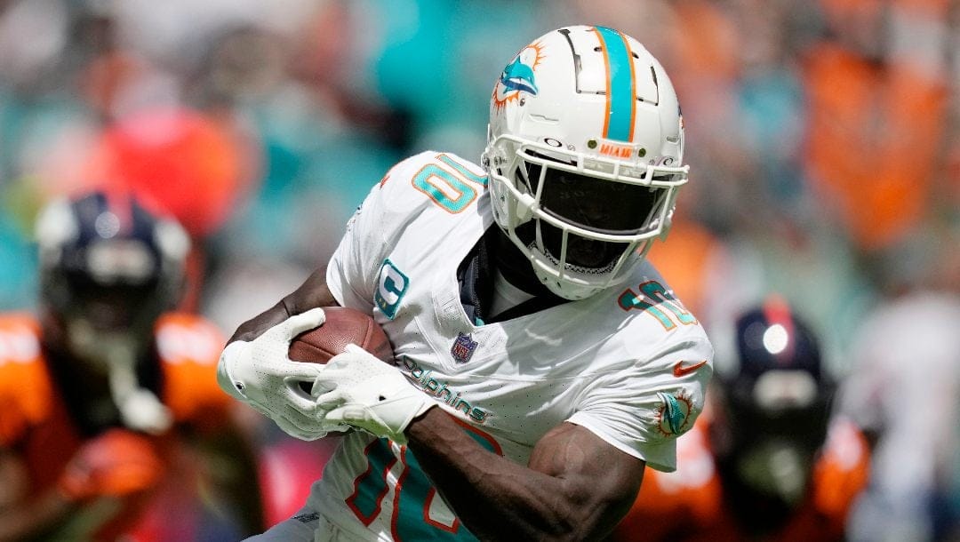 Miami Dolphins wide receiver Tyreek Hill (10) grabs a pass for a touchdown during the first half of an NFL football game against the Denver Broncos, Sunday, Sept. 24, 2023, in Miami Gardens, Fla.