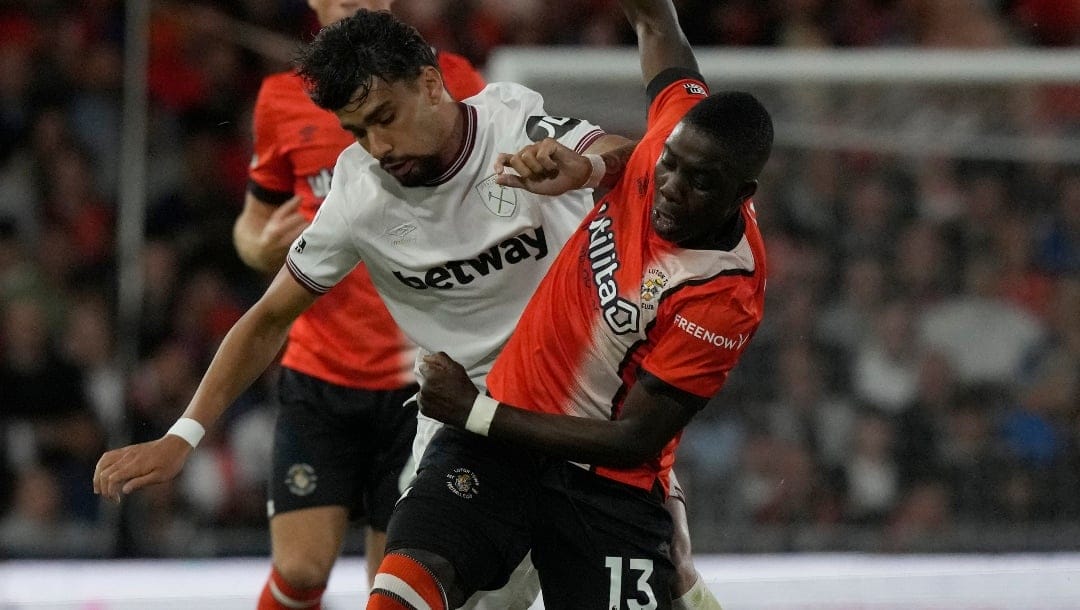 West Ham's Lucas Paqueta, left vies for the ball with Luton Town's Marvelous Nakamba during the English Premier League soccer match between Luton Town against West Ham United, in Luton, England, Friday, Sept. 1, 2023. (AP Photo/Frank Augstein)