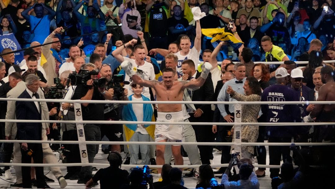 Ukraine's Oleksandr Usyk celebrates after beating Britain's Daniel Dubois during their world heavyweight title fight.