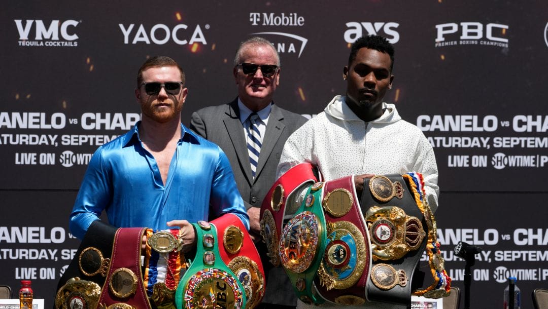 Undisputed super middleweight world champion Canelo Álvarez, left, of Mexico, TGB Promotions boxing promoter Tom Brown, center.