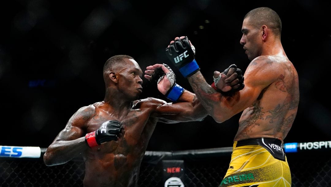 Brazil's Alex Pereira, right, fights Nigeria's Israel Adesanya during the third round of a middleweight bout title.