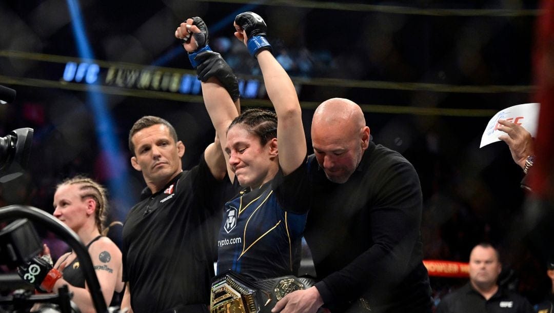 Alexa Grasso, center, receives the belt from Dana White after defeating Valentina Shevchenko in her UFC 285.