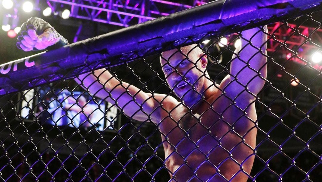 Ciryl Gane leans against the fence after defeating Derrick Lewis by technical knockout during the third round.