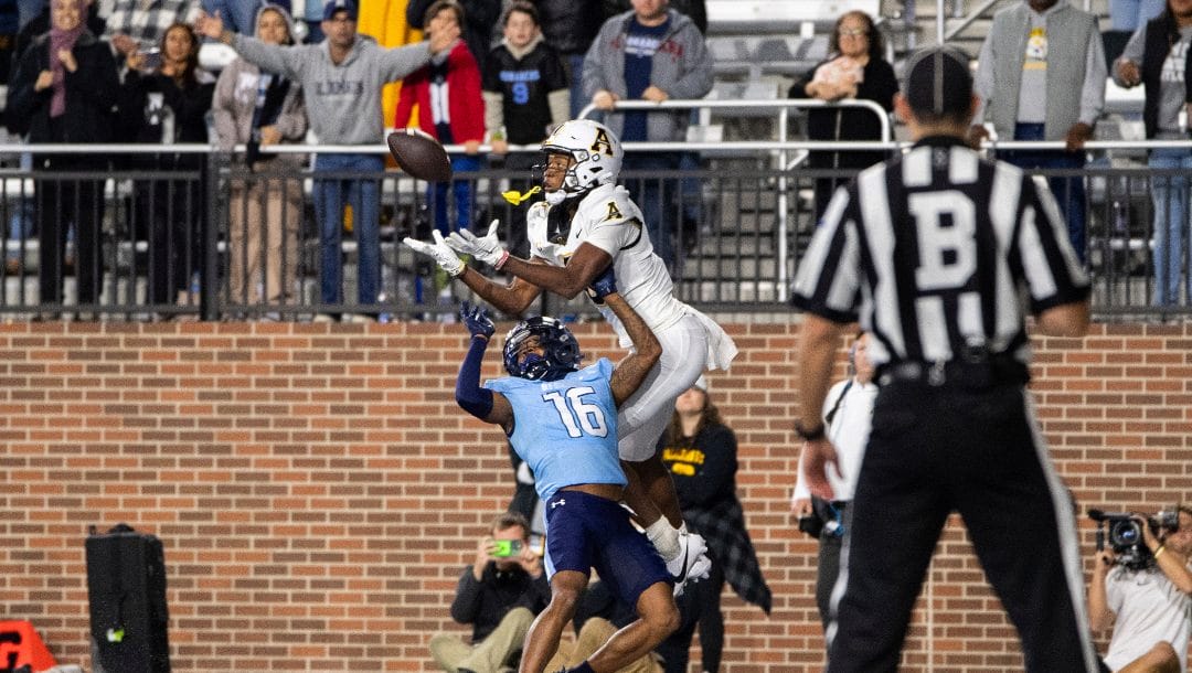 Appalachian State wide receiver Dalton Stroman, center top, reaches for the ball as he is defended by Old Dominion cornerback Khian'Dre Harris (16) during the second half of an NCAA college football game Saturday, Oct. 21, 2023, in Norfolk, Va.