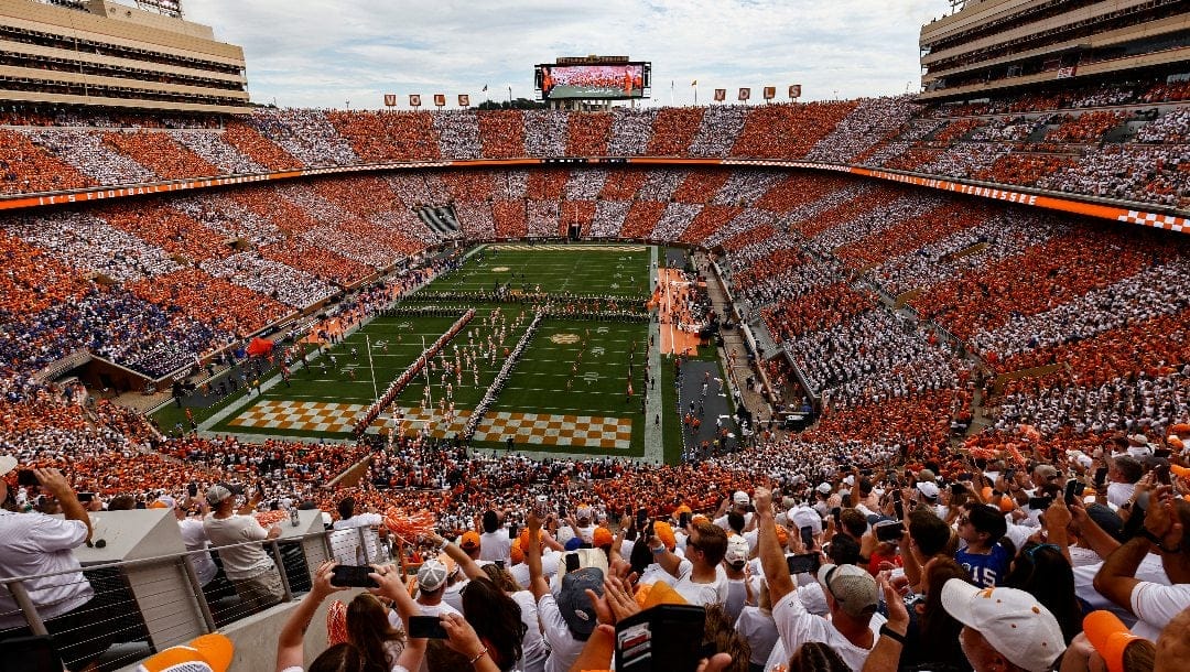 Fans fill Neyland Stadium to form the checkerboard pattern as players take the field of an NCAA college football game between Tennessee and Florida Saturday, Sept. 24, 2022, in Knoxville, Tenn.