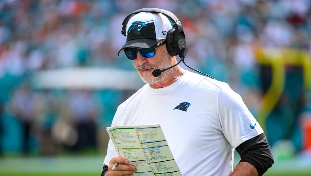 Carolina Panthers head coach Frank Reich looks at his play sheet on the sidelines during an NFL football game against and the Miami Dolphins, Sunday, Oct. 15, 2023, in Miami Gardens, Fla.