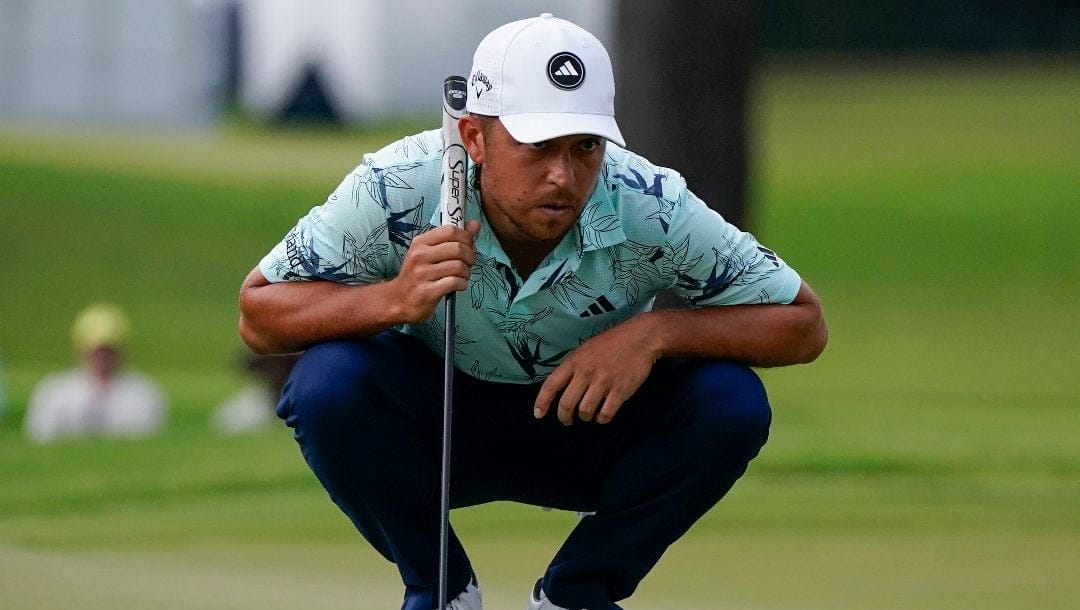 Xander Schauffele lines up a putt on the fifth green during the third round of the Tour Championship golf tournament, Sunday, Aug. 27, 2023, in Atlanta.