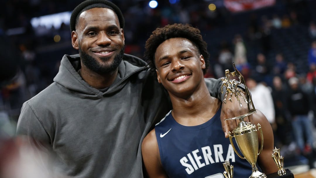 Los Angeles Lakers forward LeBron James, left, poses with his son Bronny after Sierra Canyon defeated Akron St. Vincent-St. Mary in a high school basketball game Dec. 14, 2019, in Columbus, Ohio. Bronny James joined his Southern California teammates in a preseason fan event at Galen Center, Thursday, Oct. 19, 2023.