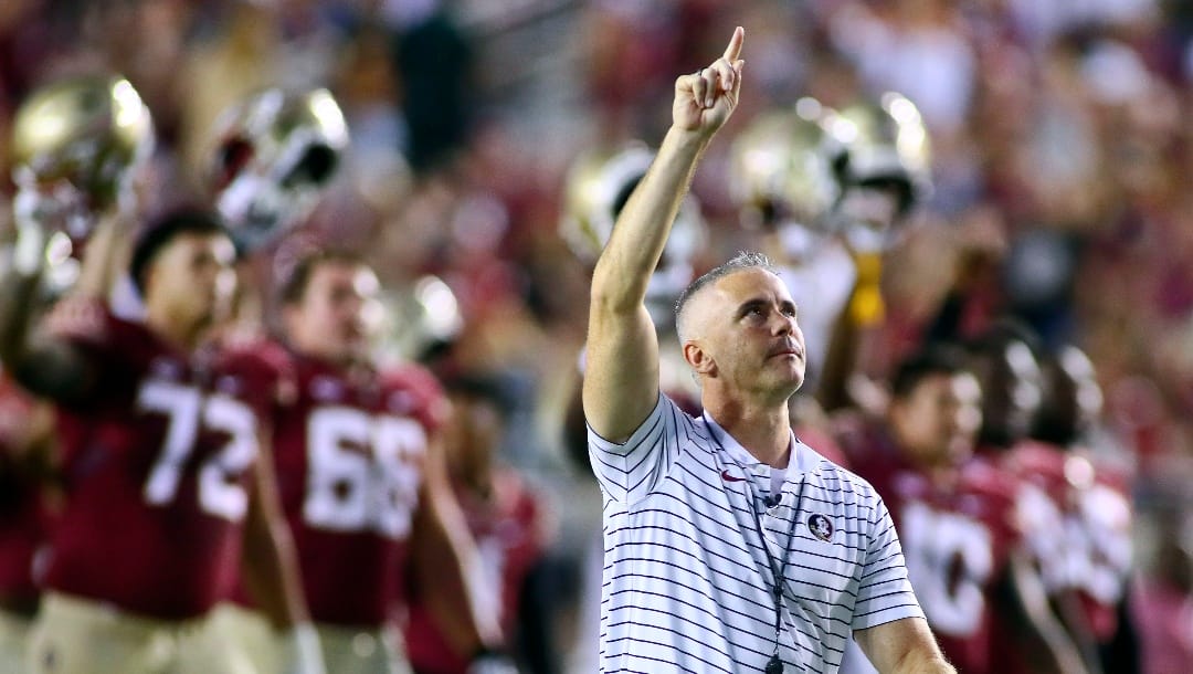 FILE - Florida State coach Mike Norvell points to the sky before the team's NCAA college football game against Clemson on Saturday, Oct. 15, 2022, in Tallahassee, Fla. Florida State faces Clemson on Sept. 23, 2023. The resurgent Seminoles have lost seven in a row against Clemson, who long ago supplanted them as the marquee team in the Atlantic Coast Conference. But this Florida State team under Norvell returns 15 starters from last year's 10-3 version and has designs on its first playoff appearance since 2014.(AP Photo/Phil Sears, File)