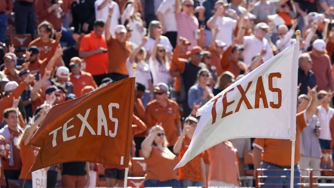 Texas fans cheer before an NCAA college football game against Oklahoma State in Austin, Texas, Saturday, Oct. 16, 2021. (AP Photo/Chuck Burton)