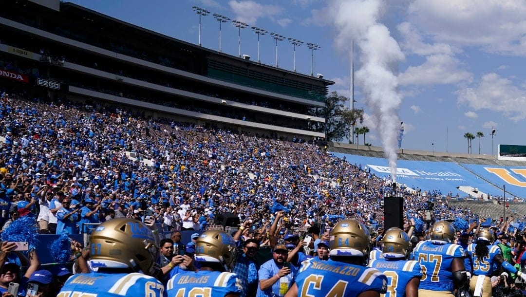 UCLA players take the field before an NCAA college football game against Utah in Pasadena, Calif., Saturday, Oct. 8, 2022. UCLA cleared a major hurdle toward joining the Big Ten Conference in 2024, getting approval for the move from the University of California Board of Regents on Wednesday, Dec. 14, 2022. (AP Photo/Ashley Landis, File)