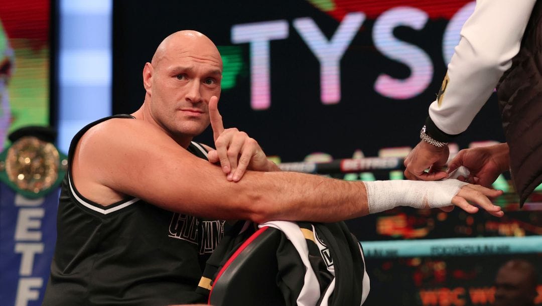 Boxer Tyson Fury the WBC heavyweight champion gestures as he is tapped up in the ring ahead of a workout at the BT Sport studios.