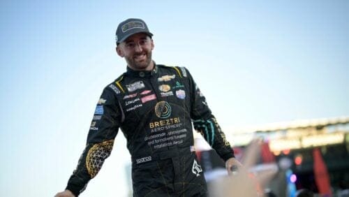 Austin Dillon slaps hands with spectators during driver introductions before a NASCAR Cup Series auto race at Daytona International Speedway, Saturday, Aug. 26, 2023, in Daytona Beach, Fla.