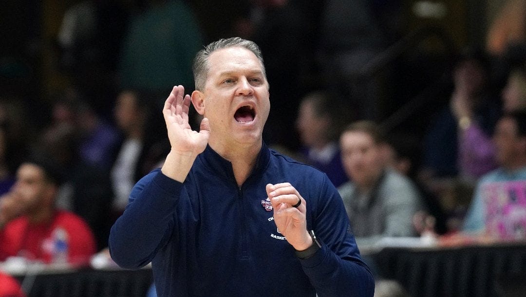 Chattanooga head coach Dan Earl directs his team during the first half of an NCAA men's college basketball championship game against Furman for the Southern Conference tournament, Monday, March 6, 2023, in Asheville, N.C. (AP Photo/Kathy Kmonicek)