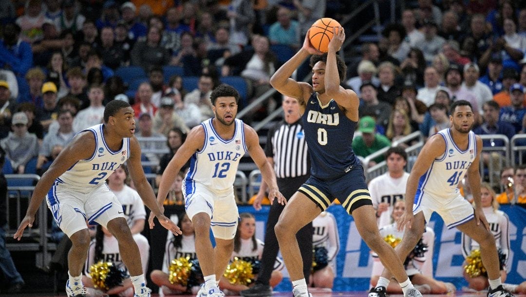 Duke guard Jaylen Blakes (2), forward Kale Catchings (12) and guard Max Johns (41) defend against Oral Roberts guard Demari Williams (0) during the second half of a first-round college basketball game in the NCAA Tournament, Thursday, March 16, 2023, in Orlando, Fla. (AP Photo/Phelan M. Ebenhack)