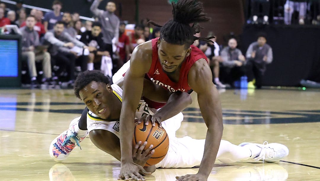 Baylor guard Dale Bonner, bottom and Nicholls State guard Micah Thomas, above, tangle for the loose ball in the second half of an NCAA college basketball game Wednesday, Dec. 28, 2022, in Waco, Texas. (AP Photo/Jerry Larson)