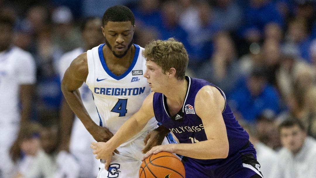 Creighton's Shereef Mitchell, left, guards against Holy Cross' Will Batchelder during the first half of an NCAA college basketball game on Monday, Nov. 14, 2022, in Omaha, Neb. (AP Photo/Rebecca S. Gratz)
