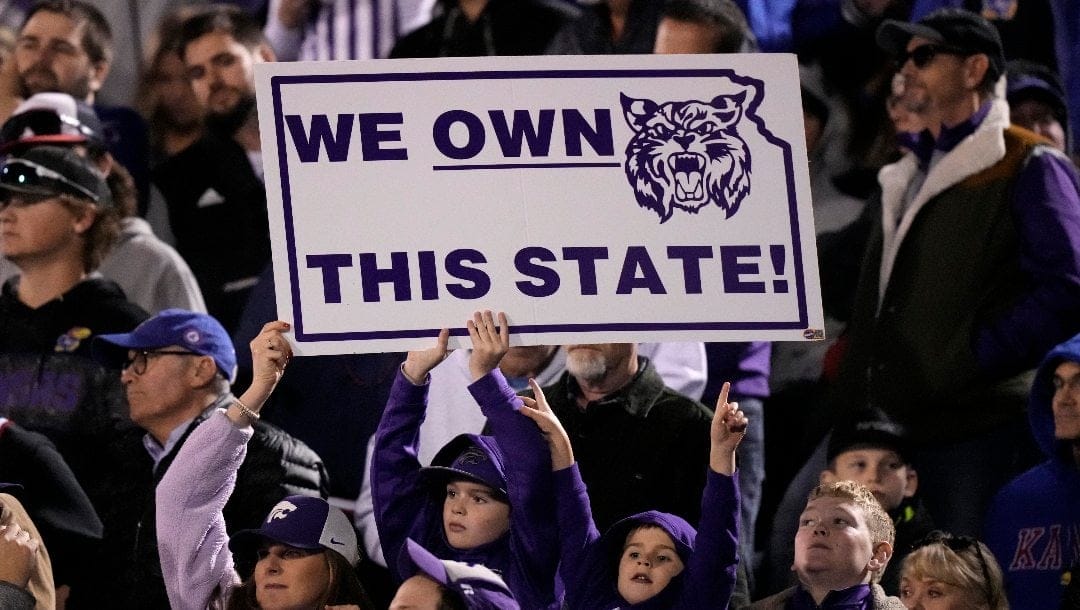 Kansas State fans hold up a sign during the second half of an NCAA college football game against Kansas Saturday, Nov. 18, 2023, in Lawrence, Kan.