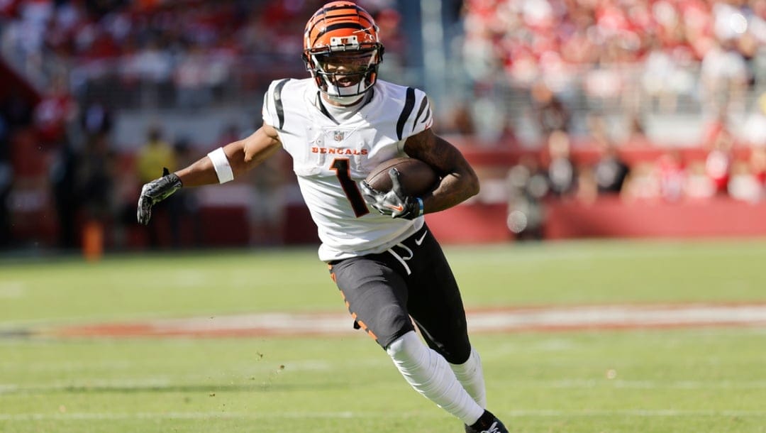 Cincinnati Bengals wide receiver Ja'Marr Chase (1) runs with the ball during the first half of an NFL football game against the San Francisco 49ers in Santa Clara, Calif., Sunday, Oct. 29, 2023.