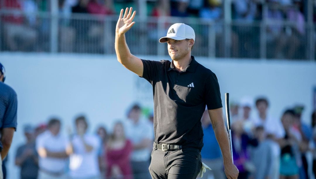 Ludvig Åberg, of Sweden, waves to the crowd after his putt on the 18th green during the final round of the RSM Classic golf tournament, Sunday, Nov. 19, 2023, in St. Simons Island, Ga.